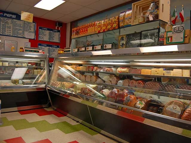 The glass deli counter and shelves inside Pastore’s Italian Delly; image date unknown